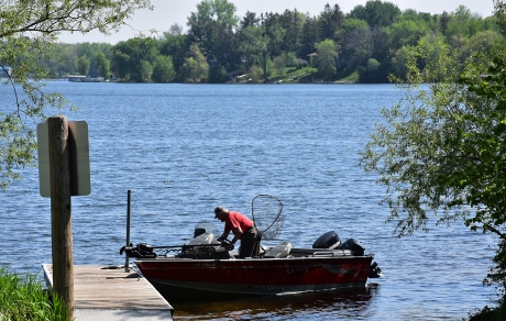 Man at dock prepares to launch boat